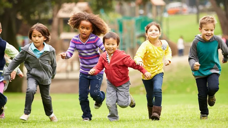 Chidlren running across grass