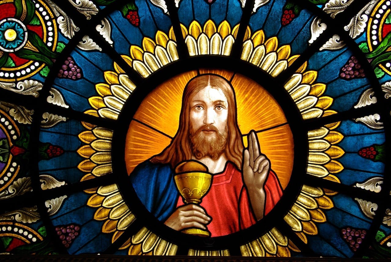 A painting of Jesus holding a chalice.